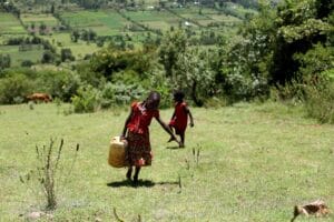 children carrying water home
